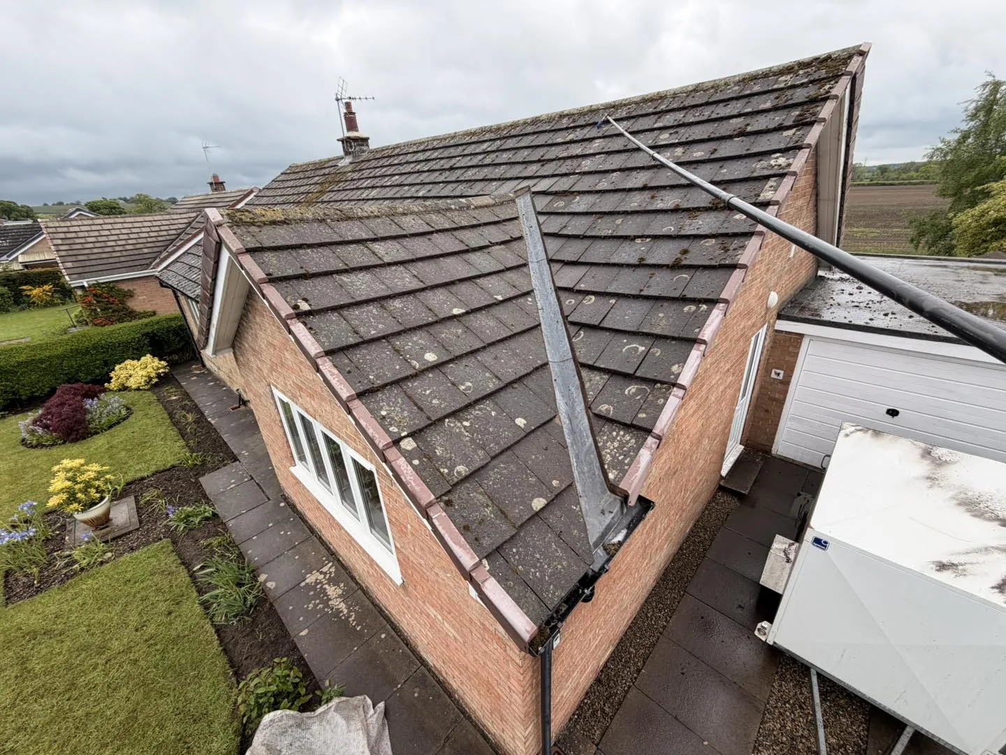 Roof cleaning safety in Thirsk: a clay tile roof soft washed free of moss without anyone walking on the tiles